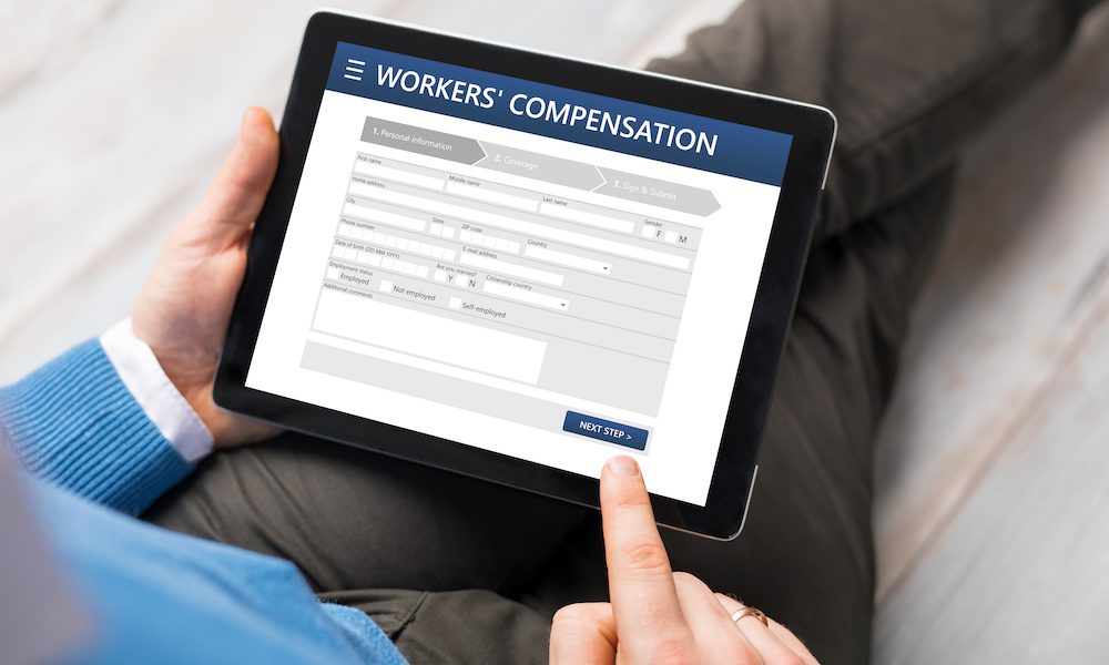 Workers' Compensation and How to Make it Work for You - Man Filling Out A Workers Compensation Form On A Tablet
